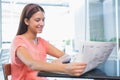 Young happy woman reading the newspaper Royalty Free Stock Photo