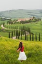 Woman in red sweater on spring Tuscany landscape