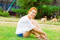 Young happy woman relaxing on green grass Royalty Free Stock Photo