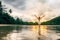 Young happy woman rising hands up enjoying beautiful sunset Royalty Free Stock Photo