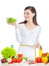 Young happy woman with salad measuring her waistline. Royalty Free Stock Photo