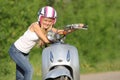 Young happy woman on scooter outdoor