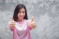 Young happy woman showing thumb up finger positively. Focus on face Royalty Free Stock Photo