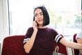 Young happy woman sitting in city bus and talking on mobile phone. Royalty Free Stock Photo