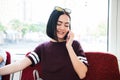 Young happy woman sitting in city bus and talking on mobile phone. Royalty Free Stock Photo