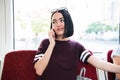 Young happy woman sitting in city bus and talking on mobile phone. Royalty Free Stock Photo