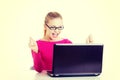 Young happy woman sitting in front of laptop. Royalty Free Stock Photo