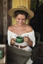 Happy woman sitting on the summer terrace and drinking coffee Royalty Free Stock Photo