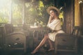 Happy woman sitting on the summer terrace and drinking coffee Royalty Free Stock Photo