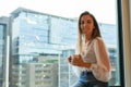 Young happy Woman Sitting on Window Sill Holding a Cup of Coffee Royalty Free Stock Photo