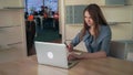 Businesswoman writing notes in notebook and check the data in the computer. Royalty Free Stock Photo