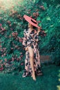 Happy woman enjoy sunlight. retro dress. Lady hiding face under vintage hat. Royalty Free Stock Photo