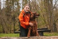 Young happy woman with sport backpack traveling with dog. A young female hugs her beloved dog. Girl and irish setter in Royalty Free Stock Photo