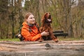 Young happy woman with sport backpack traveling with dog. A young female hugs her beloved dog. Girl and irish setter in Royalty Free Stock Photo