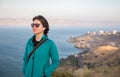 Young happy woman standing above lake, sea. Royalty Free Stock Photo