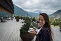 Young happy woman stands on the terrace of the hotel with cup of coffee Royalty Free Stock Photo