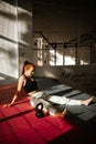 Young happy woman after Strength Training sitting on the ground. woman full of endorphins. vertical