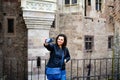 Young happy woman taking a selfie at Corvin Castle, Romania Royalty Free Stock Photo