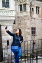 Young happy woman taking a selfie at Corvin Castle, Romania Royalty Free Stock Photo