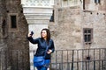 Young happy woman taking a selfie at Corvin Castle, Romania Royalty Free Stock Photo