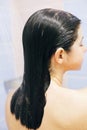 Young happy woman taking shower at home or hotel bathroom. Wet hair. Beautiful  brunette girl washing her hair and enjoying relax Royalty Free Stock Photo