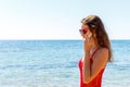 Young happy woman talking on mobile phone on a beach with sea background Royalty Free Stock Photo