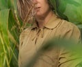 Young beautiful elegant girl in green corn field holding the stalks with her hands Royalty Free Stock Photo