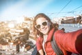 Young happy woman travel girl traveler makes selfie on a smartphone on the background of Porto, travel to Portugal, a popular Royalty Free Stock Photo