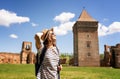 Young happy woman traveling around Serbia, against the background of a medieval fortress in Bac city Royalty Free Stock Photo