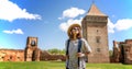 Young happy woman traveling around Serbia, against the background of a medieval fortress in Bac city Royalty Free Stock Photo