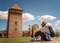 Young happy woman traveling around Serbia, against the background of a medieval fortress in Bac city Royalty Free Stock Photo