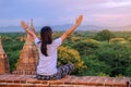 Young happy woman traveling, Asian traveler on Pagoda and looking Beautiful ancient temples, landmark and popular for tourist Royalty Free Stock Photo