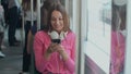 Young and happy woman using smartphone while sitting near the window in the public transport during the trip. Royalty Free Stock Photo