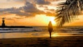 Young happy woman walking barefoot on sandy beach to palm tree branch with sea, sunset sun and lighthouse on background Royalty Free Stock Photo