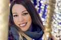 Young happy woman walking at night with christmas decorations.