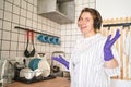 Young happy woman wash dishes at kitchen. Bright female portrait. Wow emotion Royalty Free Stock Photo