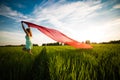 Young happy woman in wheat field with fabric Royalty Free Stock Photo