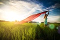 Young happy woman in wheat field with fabric Royalty Free Stock Photo