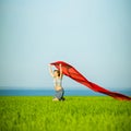 Young happy woman in wheat field with fabric Royalty Free Stock Photo