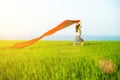 Young happy woman in wheat field with fabric. Summer lifestyle Royalty Free Stock Photo