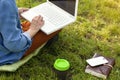 Young happy woman working with her laptop sitting on the pier, relaxing to enjoy with nature. Royalty Free Stock Photo