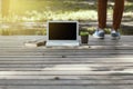 Young happy woman working with her laptop sitting on the pier, relaxing to enjoy with nature. Royalty Free Stock Photo