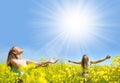 Young happy womans on blooming rapeseed field Royalty Free Stock Photo