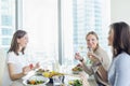 Young happy women enjoying dinner together Royalty Free Stock Photo