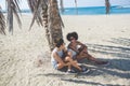 Young happy women relaxing on beach laughing Royalty Free Stock Photo