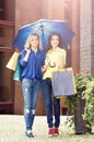 Young and happy women with shopping bags in the city Royalty Free Stock Photo