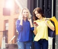 Young and happy women with shopping bags in the city Royalty Free Stock Photo