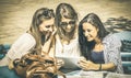 Young happy women studying and having fun together with tablet