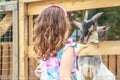 Young happy young girl feeding goat on farm Royalty Free Stock Photo