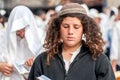 Young hasid pilgrim in the crowd on the city street. Holiday Rosh Hashanah, Jewish New Year.
